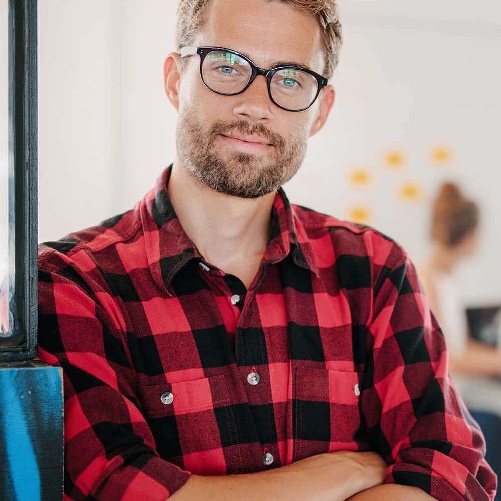 portrait-of-positive-businessman-in-office-PNPWR2X.jpeg